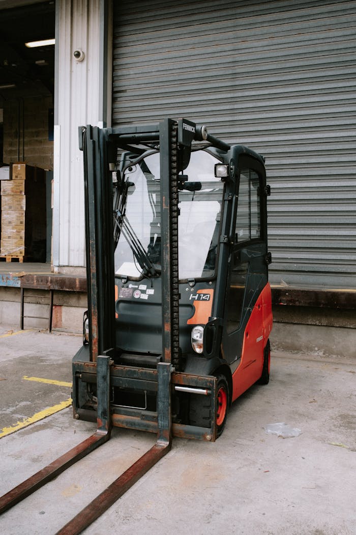 cta-02 Close-up of a parked forklift in an industrial warehouse dock area.